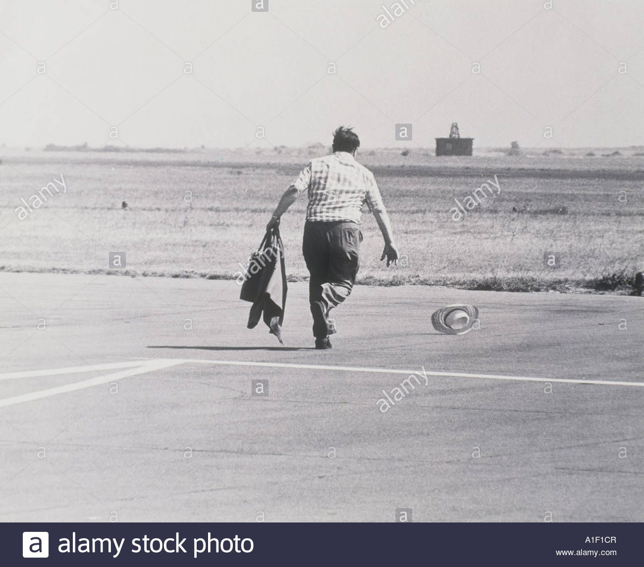 man-chasing-his-hat-blown-by-the-wind-A1F1CR.jpg